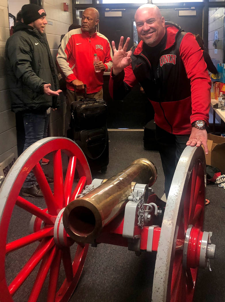 UNLV football head coach Tony Sanchez smiles with the Fremont Cannon after UNLV beat UNR 33-30 ...