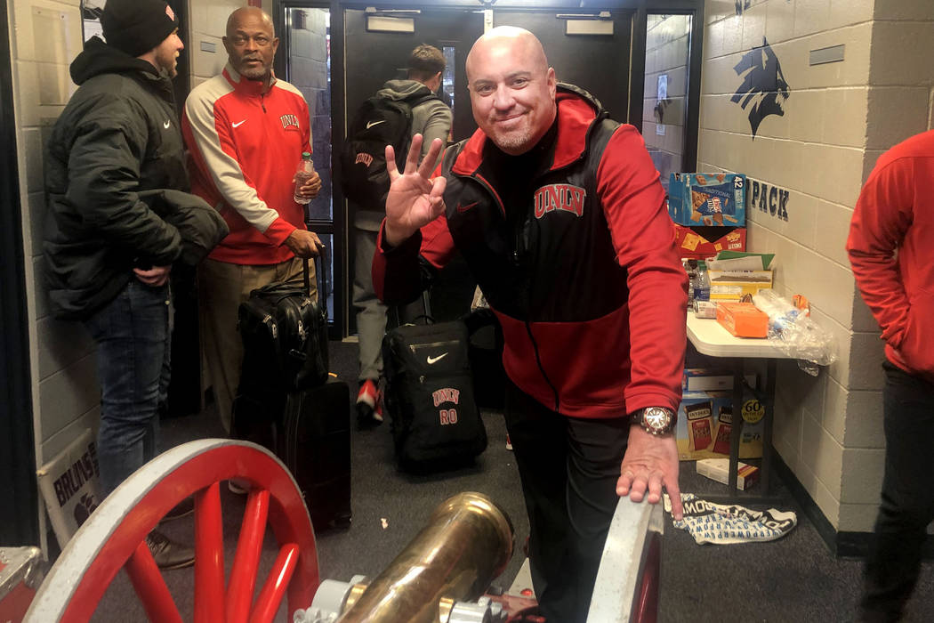 UNLV football head coach Tony Sanchez smiles with the Fremont Cannon after UNLV beat UNR 33-30 ...