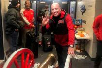 UNLV football head coach Tony Sanchez smiles with the Fremont Cannon after UNLV beat UNR 33-30 ...