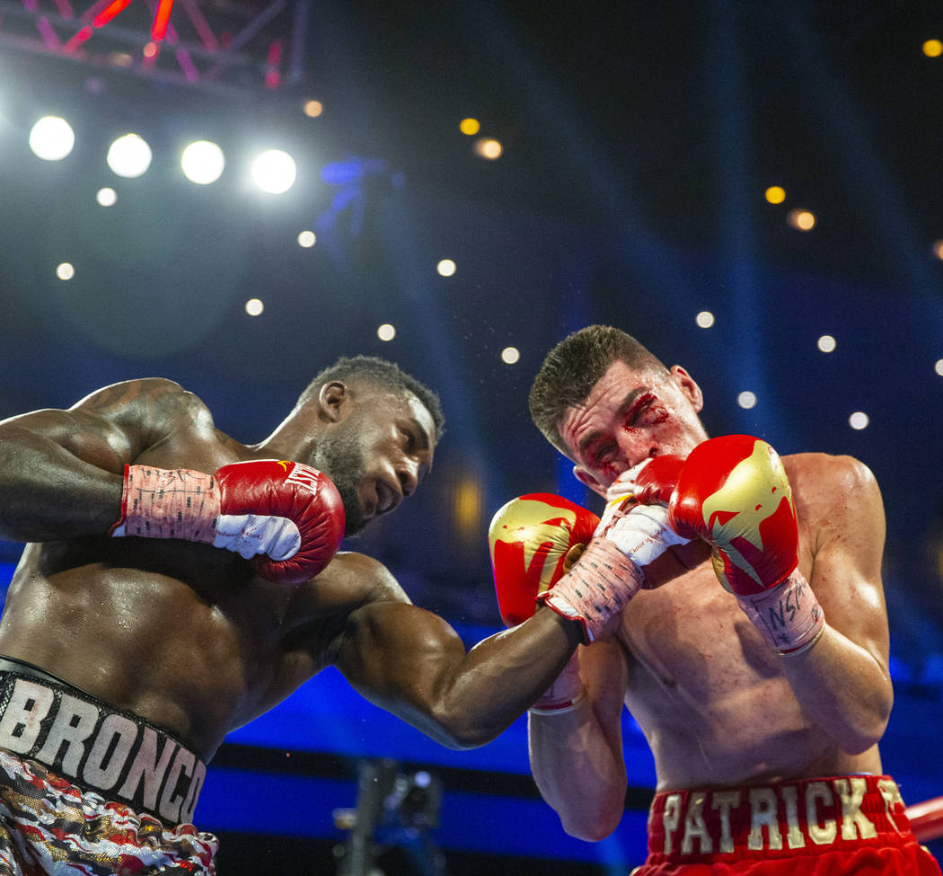 Carlos Adames, left, punches Patrick Teixeira during round 5 in their super welterweight fight ...