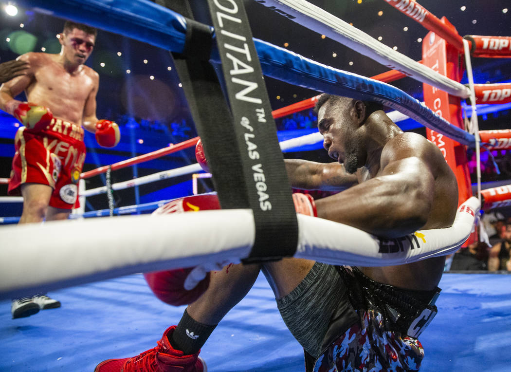 Patrick Teixeira, left, knocks down Carlos Adames during round 7 in their super welterweight fi ...