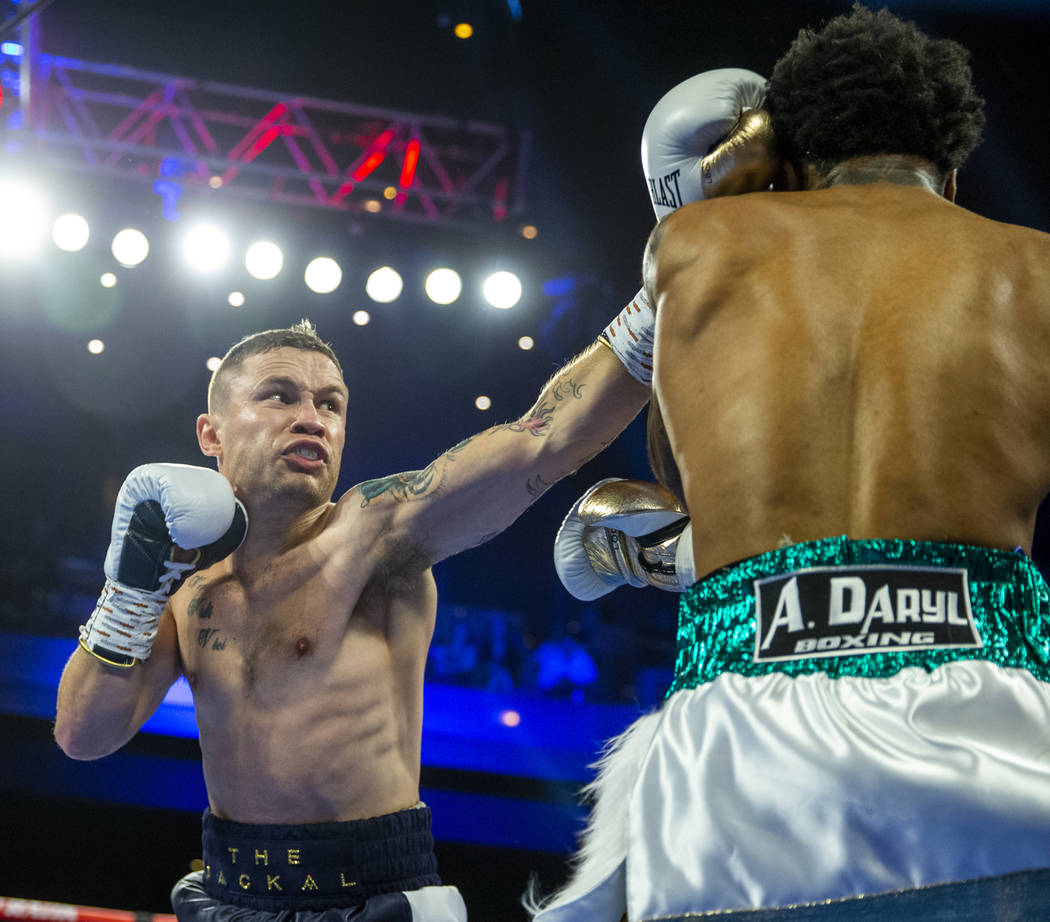 Carl Frampton, left, connects on the face of Tyler McCreary during round 1 of their WBC super f ...