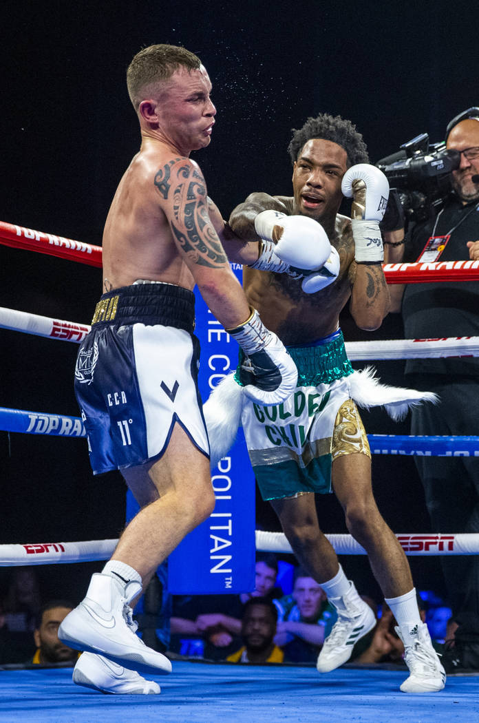 Carl Frampton, left, gets caught with a shot to the chin by Tyler McCreary during round 10 of t ...