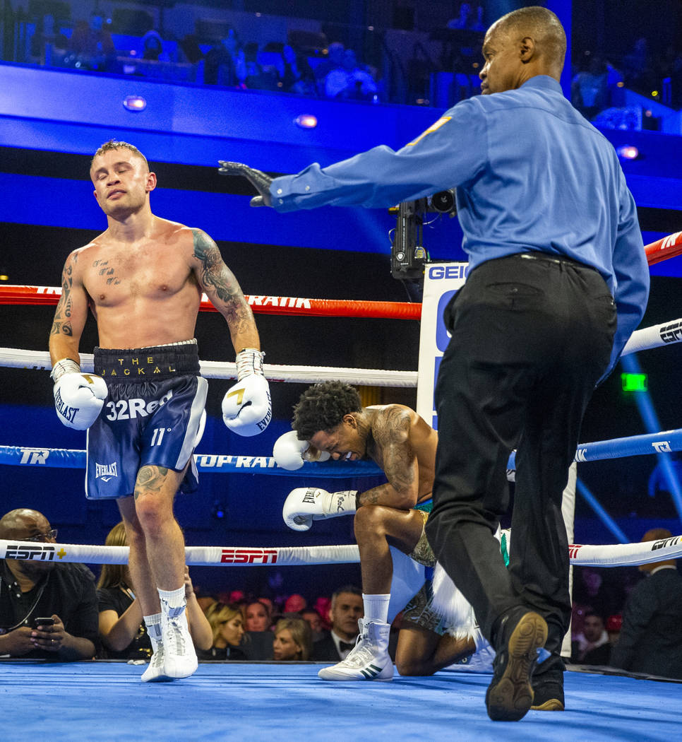 Carl Frampton, left, walks away from Tyler McCreary as he clings to the ropes during round 6 of ...