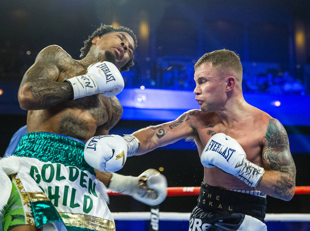 Tyler McCreary, left, takes a punch to the ribs from Carl Frampton during round 8 of their WBC ...