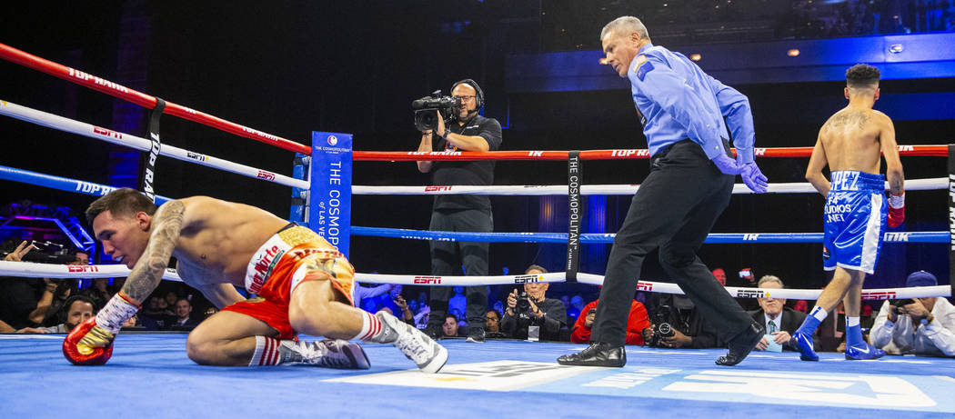 Oscar Valdez, left, is on the canvas after a shot from Adam Lopez during round 2 of their WBC s ...