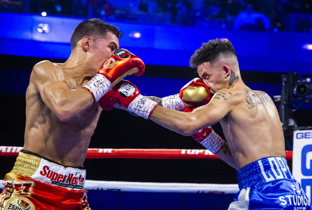 Oscar Valdez, left, trades punches with Adam Lopez during round 3 of their WBC super featherwei ...