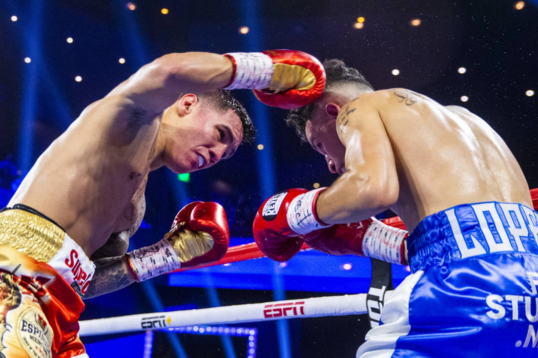 Oscar Valdez, left, connects with an overhand right on Adam Lopez during round 3 of their WBC s ...