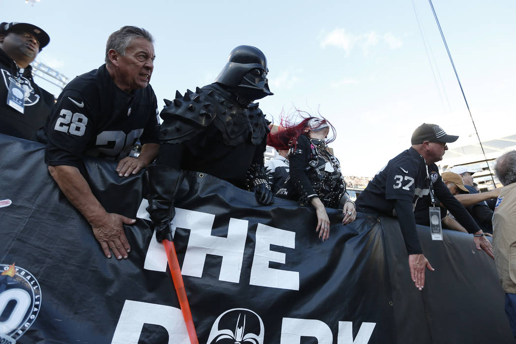 Oakland Raiders fans watch during the second half of an NFL football game between the Raiders a ...