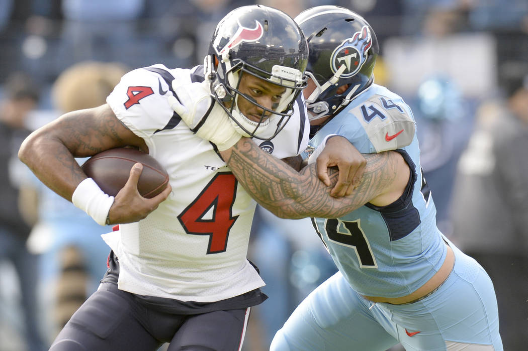 Houston Texans quarterback Deshaun Watson (4) is stopped by Tennessee Titans outside linebacker ...