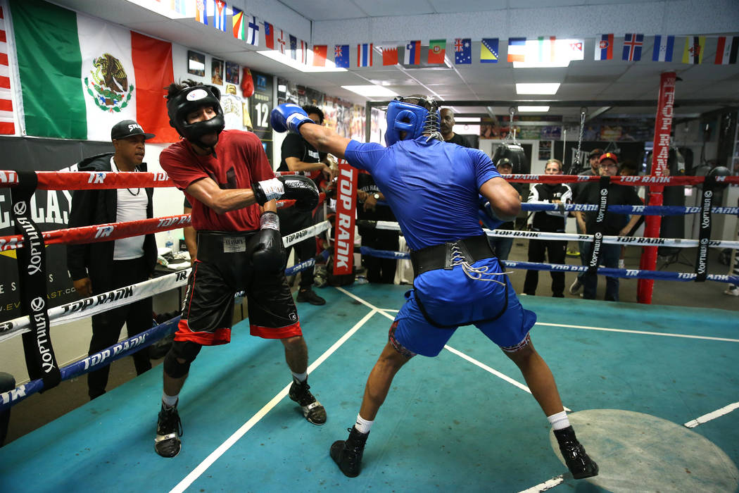 Boxer Devin Haney, right, connects a punch against Cesar Valenzuela while sparring in preparati ...