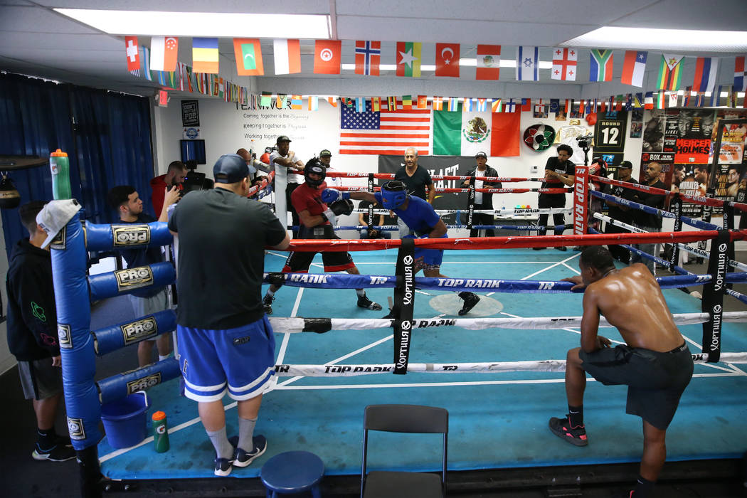 Boxer Devin Haney, right, connects a punch against Cesar Valenzuela while sparring in preparati ...
