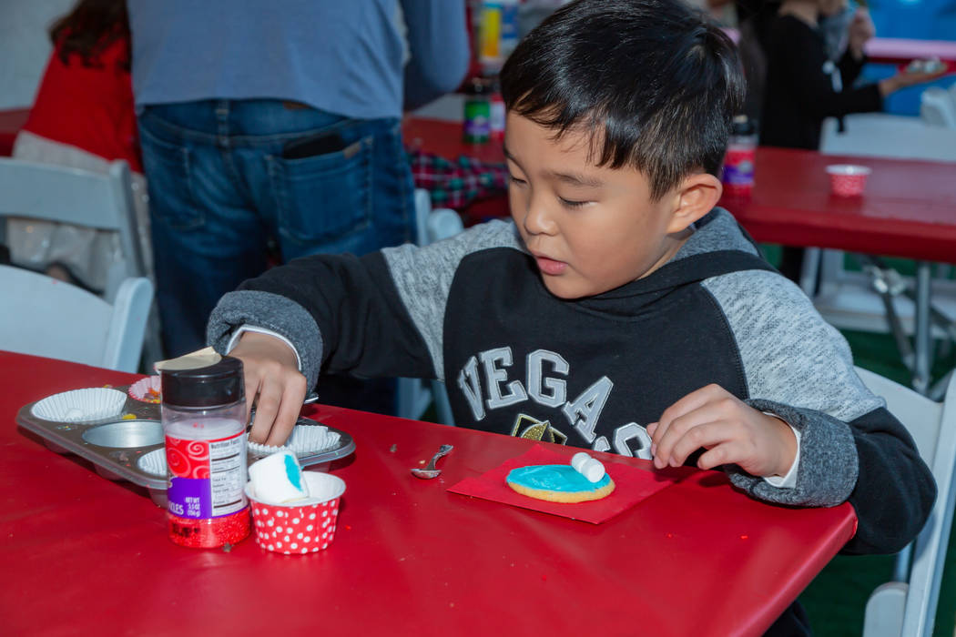 A participant of Holiday Express at Springs Preserve decorates a cookie. (Springs Preserve)