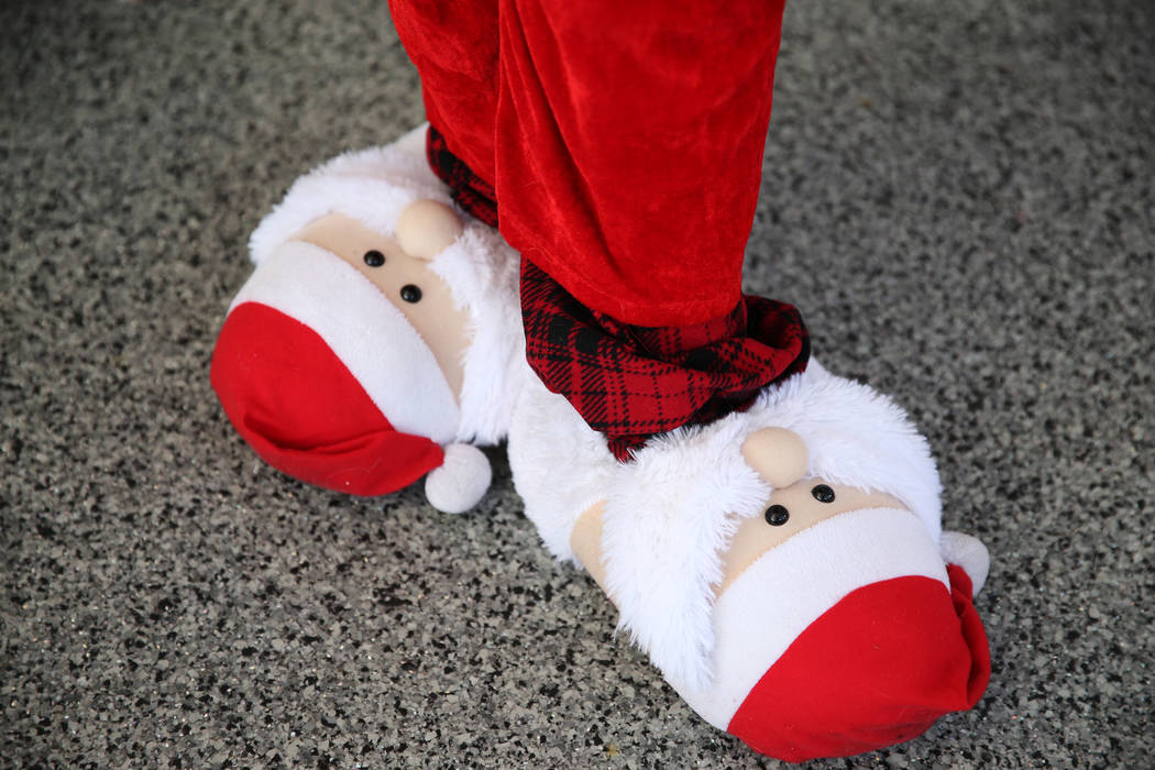 A runner wears Santa Claus themed slippers for the 14th annual Las Vegas Great Santa Run in Las ...
