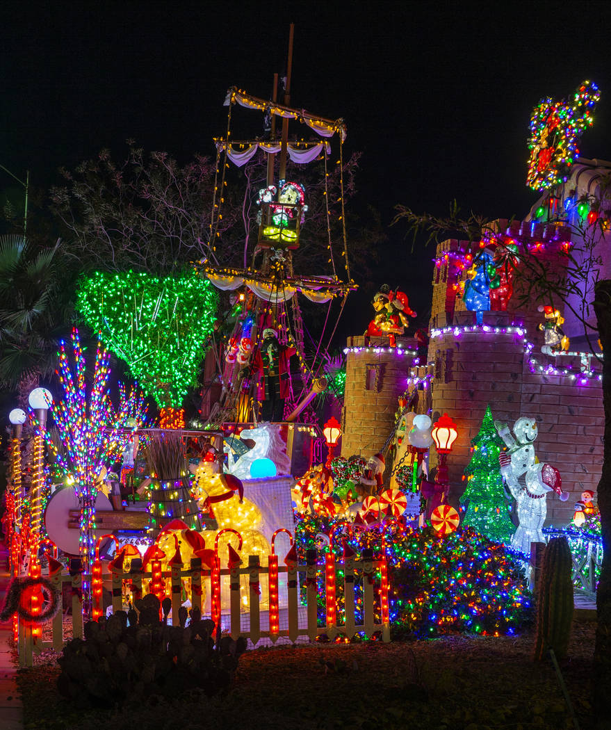 A pirate ship and castle anchor the holiday lights display in the yard of Maria Acosta and Juan ...