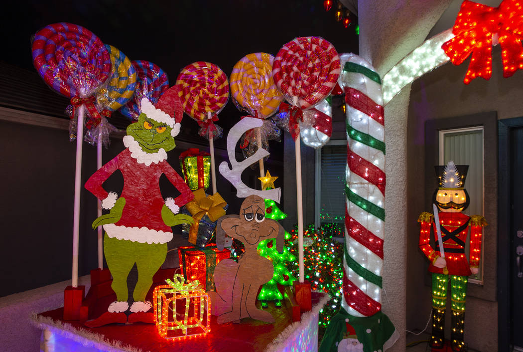 The Grinch Who Stole Christmas is part of the holiday lights display in the yard of Maria Acost ...