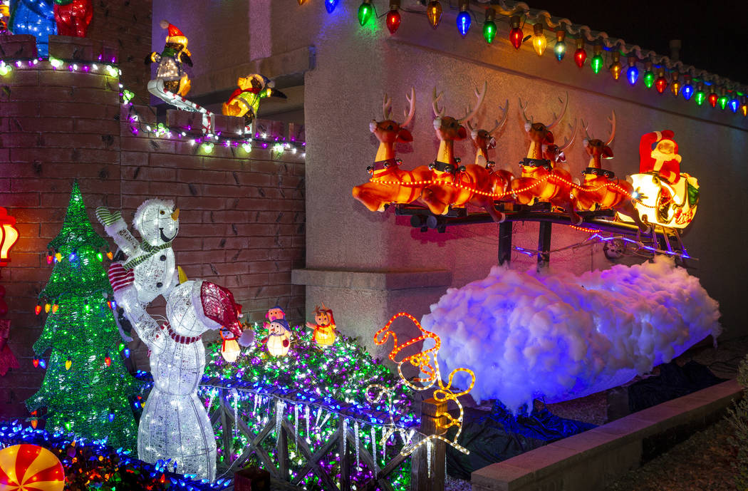 Santa on his sleigh as part of the holiday lights display in the yard of Maria Acosta and Juan ...