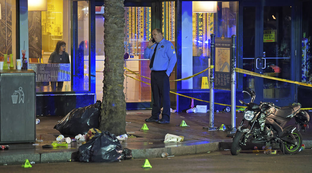 A woman looks out from inside a McDonald's fast food restaurant as New Orleans police investiga ...