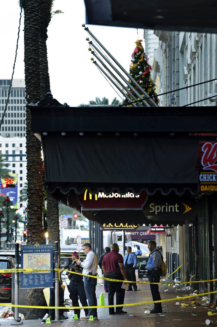 New Orleans police investigate the scene of a shooting Sunday, Dec. 1, 2019, on the edge of the ...