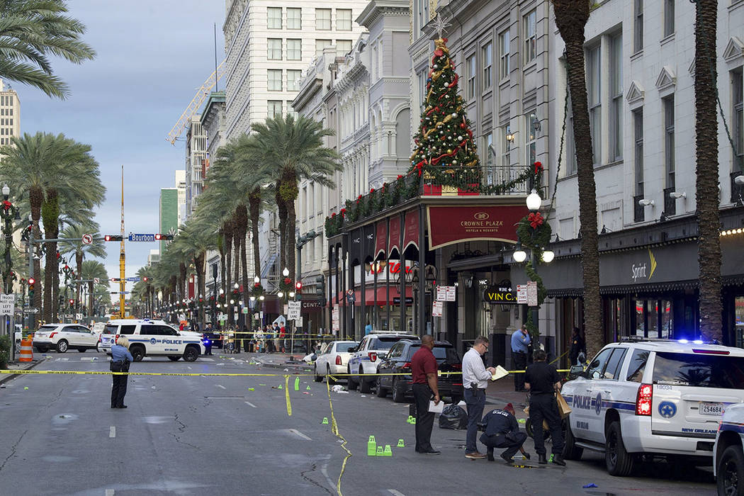 New Orleans police investigate the scene of a shooting Sunday, Dec. 1, 2019, on the edge of the ...