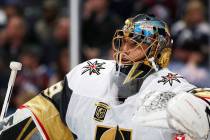 Vegas Golden Knights goaltender Marc-Andre Fleury leans on the top of the net during a time out ...