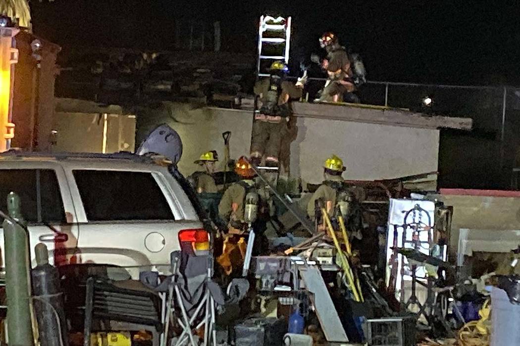 Fire crews work on a fire in a guest house near North Campbell and West Lone Mountain roads on ...