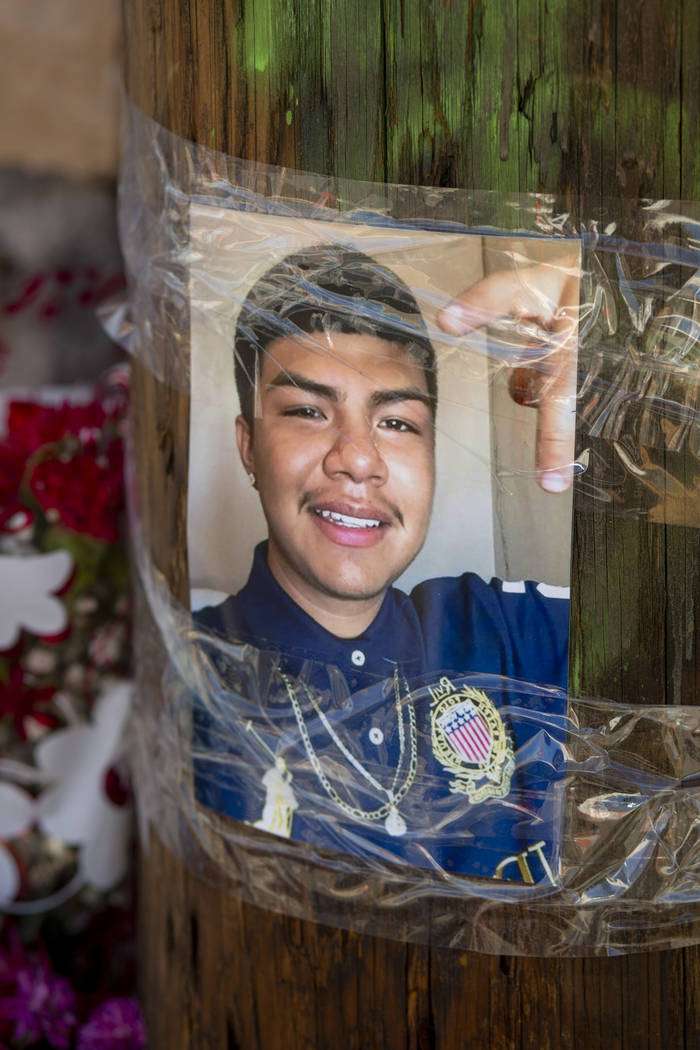 A photograph is hung at a memorial site for Kevin Soriano, 17, of North Las Vegas, who was shot ...