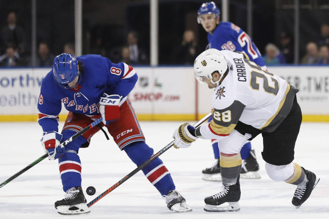 New York Rangers defenseman Jacob Trouba (8) searches for the puck as Vegas Golden Knights left ...