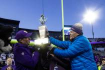 Washington Governor Jay Inslee hands Washington head coach Chris Petersen the Apple Cup after a ...