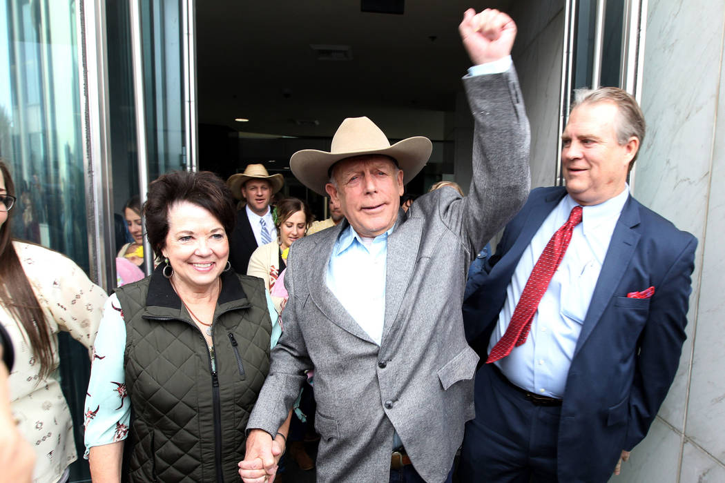 Cliven Bundy walks out of Lloyd George U.S. Courthouse in Las Vegas a free man with his wife Ca ...