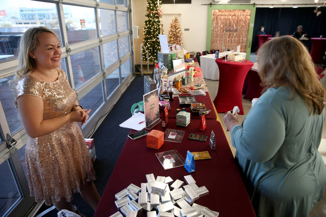 Zappos Fungineer Katie Valencia, left, helps Customer Loyalty Team member Teri McNally pick ou ...