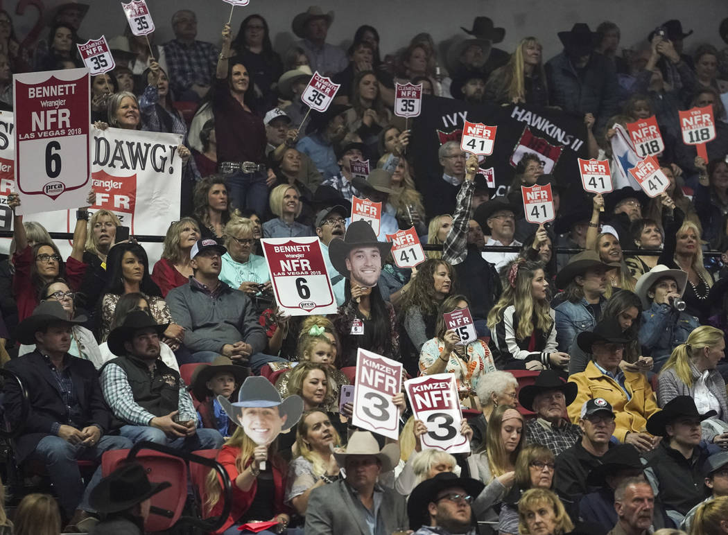 Spectators cheer during the eighth go-round of the National Finals Rodeo at the Thomas & Ma ...