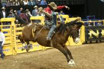 Isaac Diaz of Texas competes in the saddle bronc riding during the third go-round of the Nation ...
