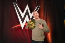 NASCAR Monster Cup champion Kyle Busch poses with the WWE title belt. (True Speed Communications)