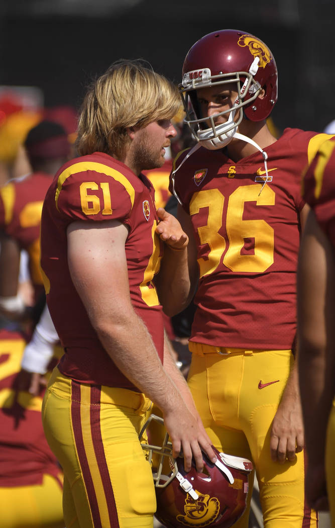 Southern California long snapper Jake Olson, left, who is blind, talks with punter Chris Tilbey ...
