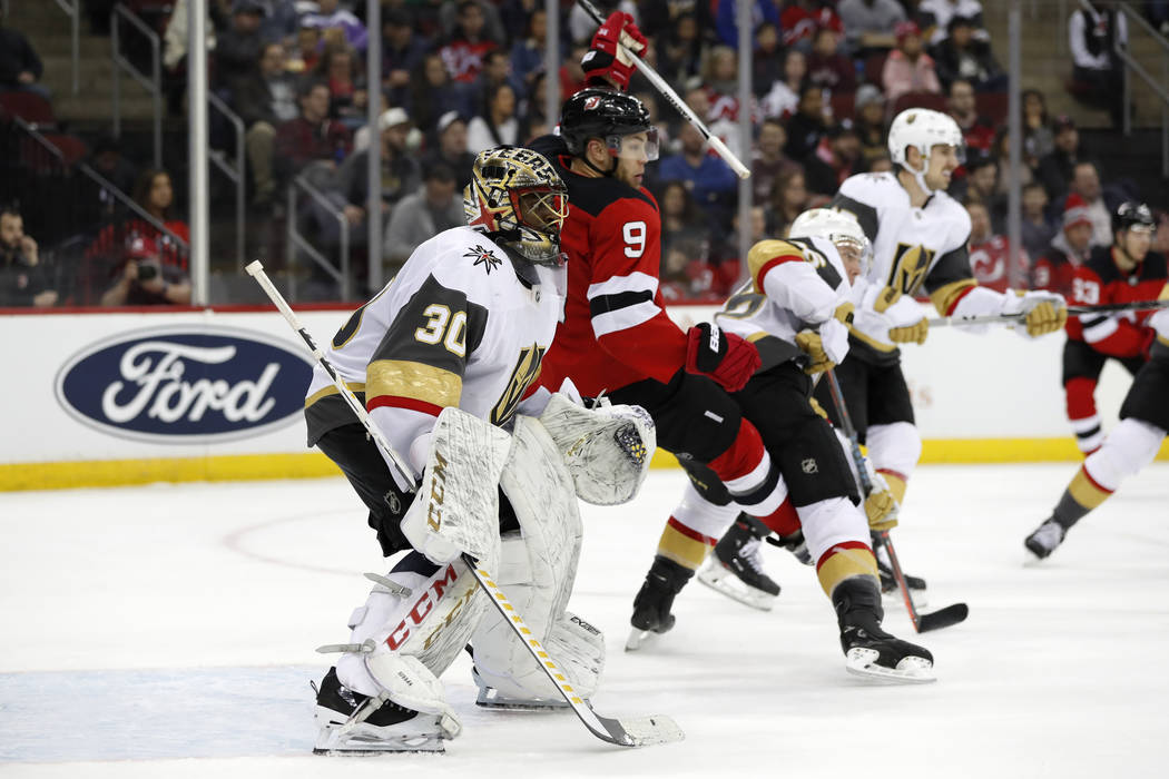 New Jersey Devils left wing Taylor Hall (9) trips in front of Vegas Golden Knights goaltender M ...