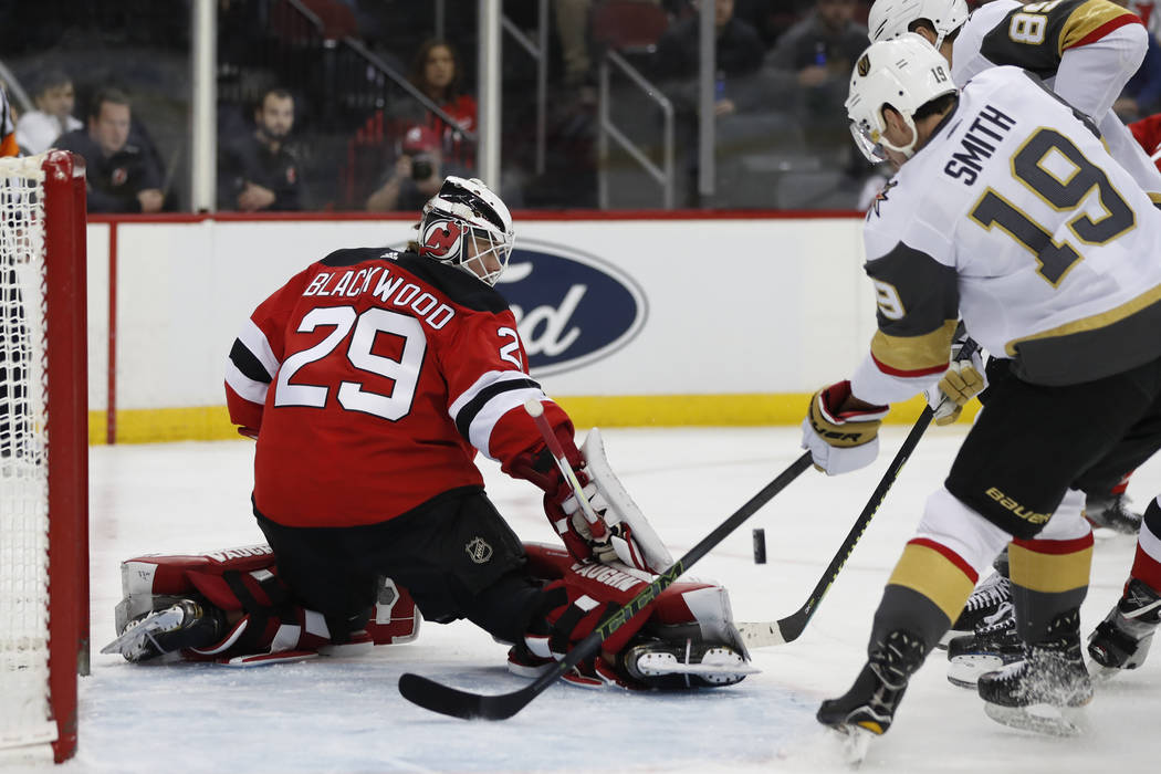 New Jersey Devils goaltender Mackenzie Blackwood (29) blocks a shot with Vegas Golden Knights r ...