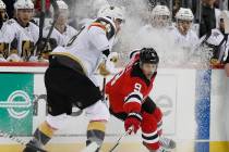 New Jersey Devils left wing Taylor Hall (9) tries to corral the puck away from Vegas Golden Kni ...