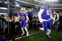 Buffalo Bills wide receiver Cole Beasley (10) and guard Quinton Spain (67) rush onto the field ...