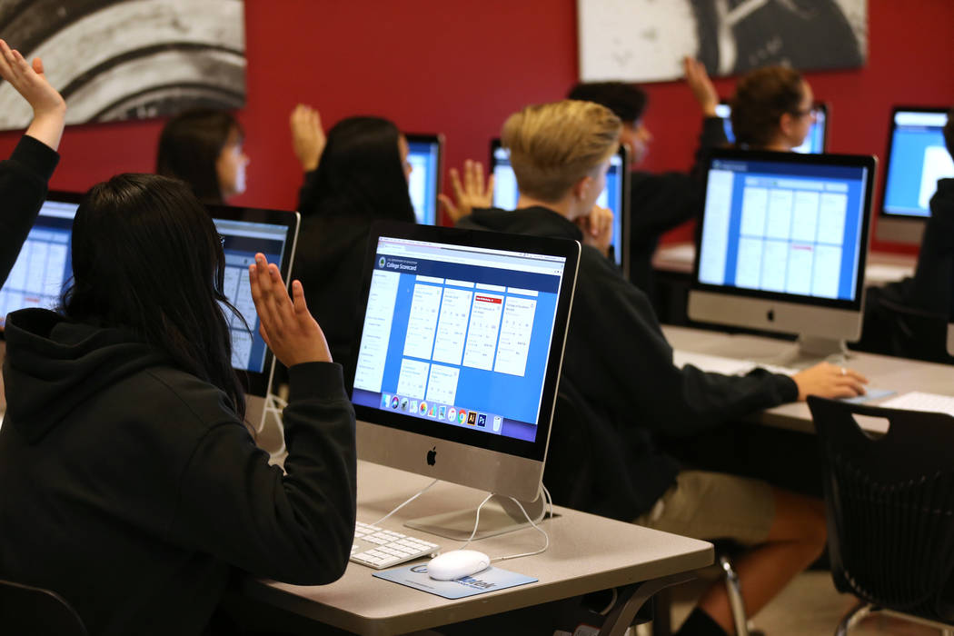 Students raise their hands after a question from Secretary of Education Betsy DeVos during her ...