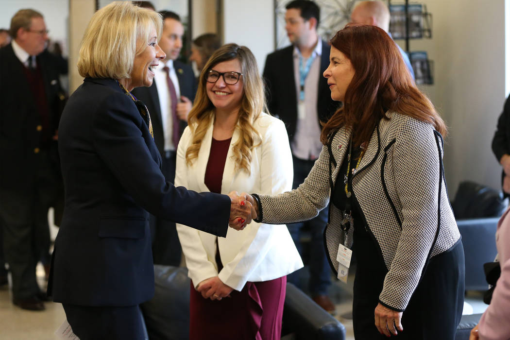 Secretary of Education Betsy DeVos, left, shakes hands with Henderson Mayor Debra March during ...