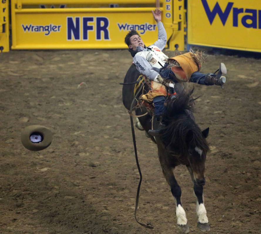 Clayton Biglow of Clements, Calif. (10) rides "Top Flight" while competing in barebac ...