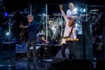 Roger Daltrey and guitarist Pete Townshend of The Who finish the song "Who Are You" a ...