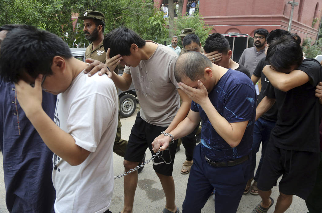 In a May 11, 2019, file photo, detained Chinese nationals, accused of involvement in a traffick ...