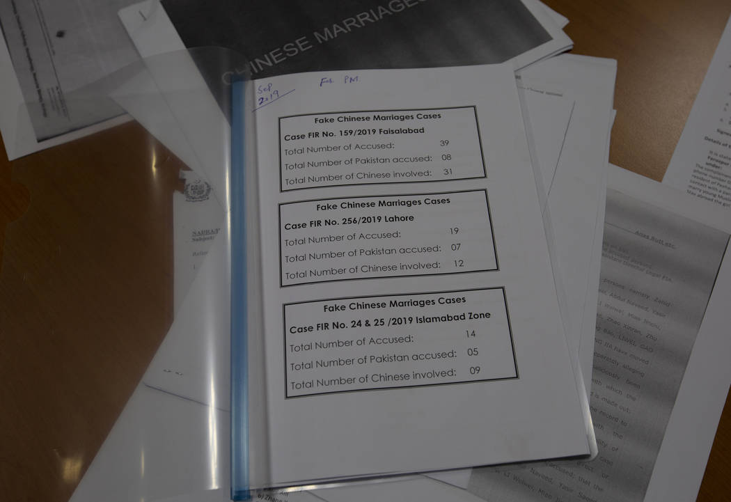 In a Nov. 21, 2019, photo, a pile of documents related to the trafficking of Pakistani brides t ...