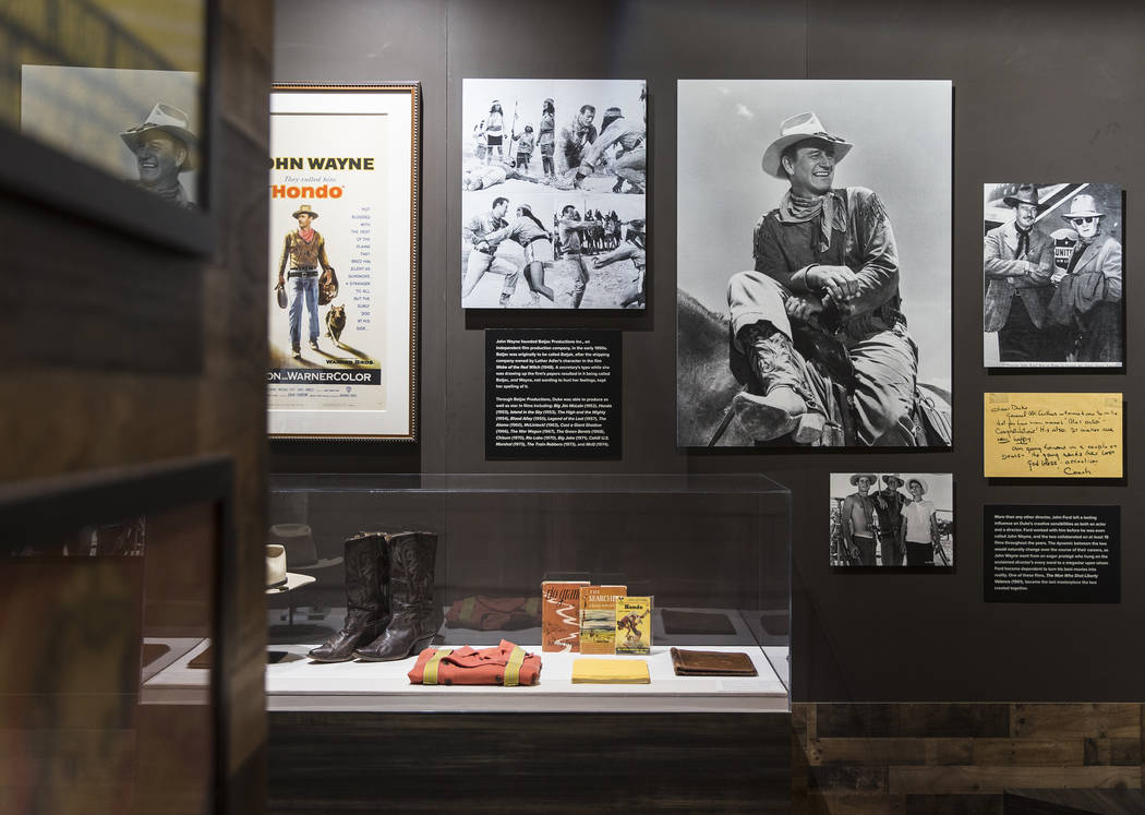 Photographs of movie icon John Wayne line the walls of the "John Wayne: Spirit of the West ...