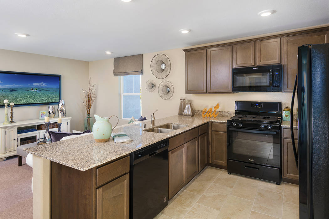 The 1,002-square-foot Griffin town home has a well-equipped kitchen and great room. (Mark Skaln ...