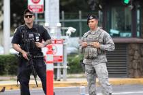 Security stands guard outside the main gate at Joint Base Pearl Harbor-Hickam, in Hawaii, Wedne ...