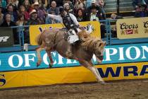 Chase Brooks of Deer Lodge, Mont. (111) competes in the saddle bronc riding event during the ei ...