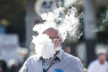 Derick Rainey takes a vape break outside the Las Vegas Convention Center during the World of Co ...